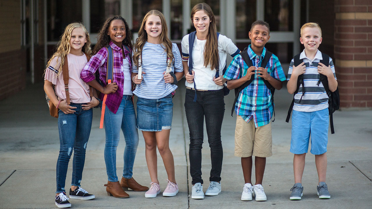 2024 NAEP Mathematics Assessment: Group of students standing outside of a school building.